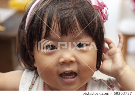 Up of a girl with a headband Up of a girl with a headband 69203737