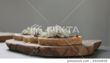 bruschettas with panchetta, ricotta and fig marmalade on ciabatta bread 69204694