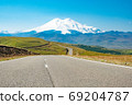 Panorama road leading to the Jilli-su trace against the background of the highest peak in Europe, mount Elbrus  69204787