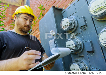 Electrical engineer on during checking in yellow Electrical engineer on during checking in yellow 69205456