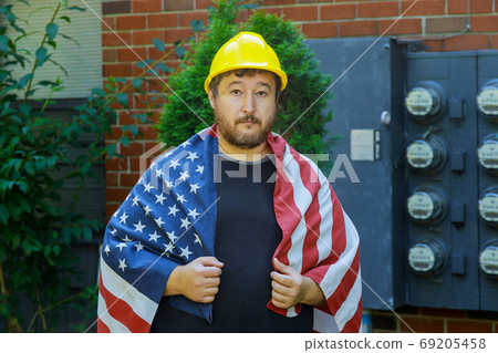 Labor day concept for worker in a yellow helmet 69205458
