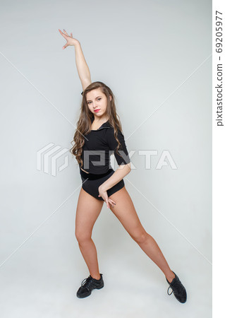Attractive and young woman with long hair in black clothes. 69205977
