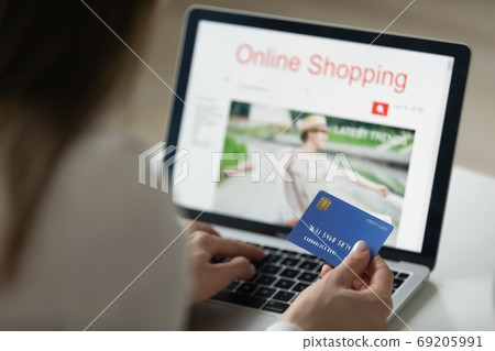 Close up young woman involved in online shopping on laptop. 69205991