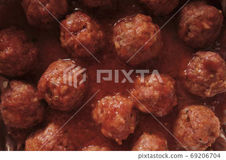 Culinary background - meatballs in red tomato sauce, top view, close-up 69206704
