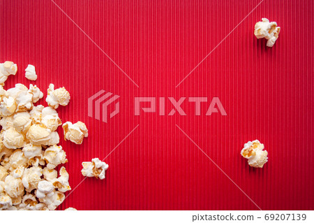 Popcorn on red background Popcorn on red background 69207139