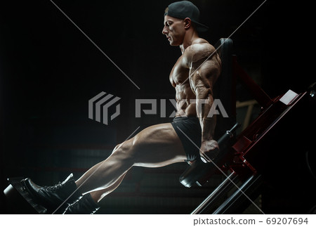 bodybuilder fitness man pumping up legs muscles bodybuilder fitness man pumping up legs muscles 69207694