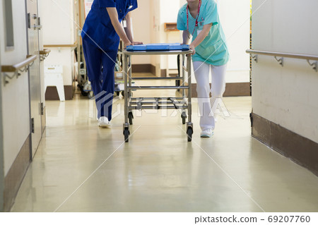 Medical worker pushing stretcher 69207760