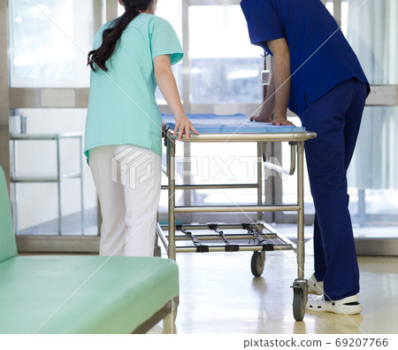 Medical worker pushing stretcher 69207766