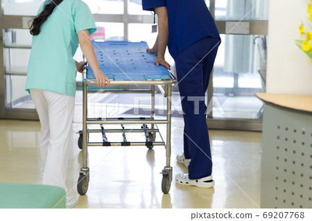 Medical worker pushing stretcher 69207768