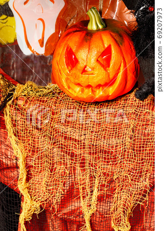 Halloween holiday, a fun ghost with a glowing pumpkin instead of a head. 69207973