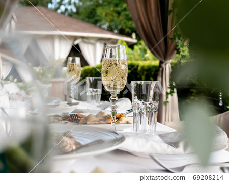 Glasses of sparkling wine on the table in an outdoor restaurant. 69208214