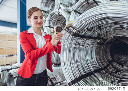 Bookkeeper during audit and stocktaking in inventory warehouse Bookkeeper during audit and stocktaking in inventory warehouse 69208745