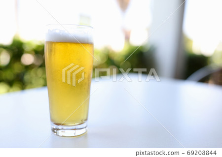 Glass alcoholic beer is on table in bar Glass alcoholic beer is on table in bar 69208844