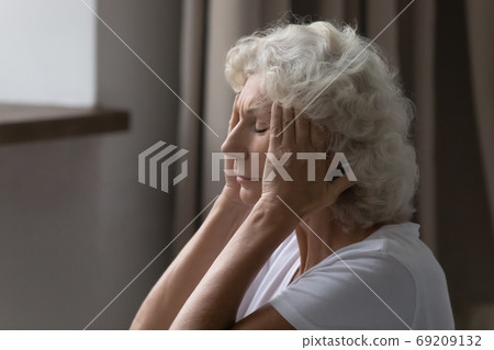 Close up frustrated exhausted mature woman touching temples, feeling pain Close up frustrated exhausted mature woman touching temples, feeling pain 69209132
