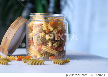 Variety of types and shapes of dry Italian pasta in a jar  69209651