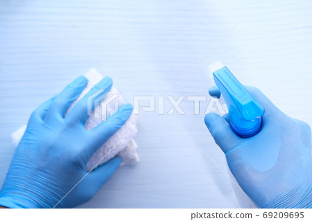 hand in disposable gloves using disinfectant spray to clean table surface, hand in disposable gloves using disinfectant spray to clean table surface, 69209695