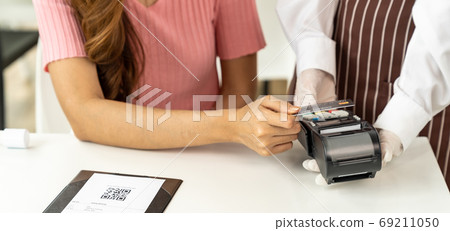 Panoramic Close up Asian woman customer make contactless credit Panoramic Close up Asian woman customer make contactless credit 69211050