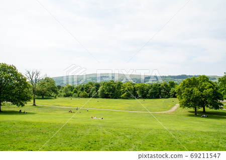 People relaxing on a spacious lawn in a park outside Edinburgh People relaxing on a spacious lawn in a park outside Edinburgh 69211547