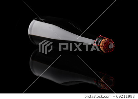 Champagne bottle lying on black background with reflection. Champagne bottle lying on black background with reflection. 69211998