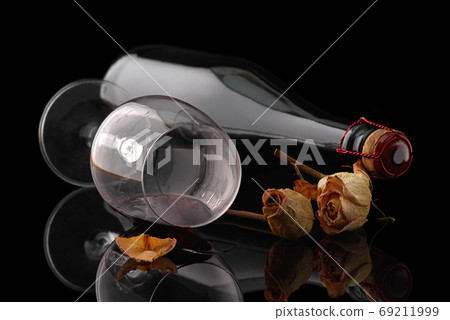 bottle with a wineglass on black background bottle with a wineglass on black background 69211999