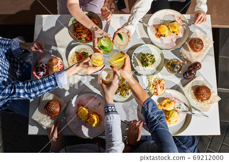Group of happy friends having nice food and drinks, enjoying the party and communication, Top view Group of happy friends having nice food and drinks, enjoying the party and communication, Top view 69212000