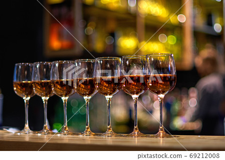 Lots of glasses of wine in a row at the bar counter Lots of glasses of wine in a row at the bar counter 69212008