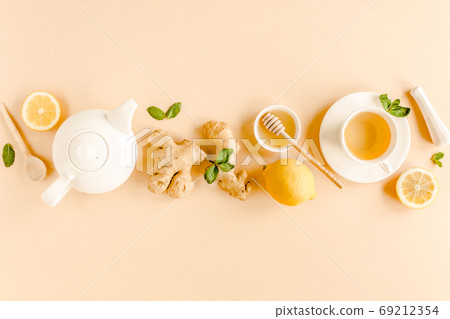 Herbal tea with mint, ginger, lemon, honey and other herbs on yellow background. Flat lay, top view. 69212354