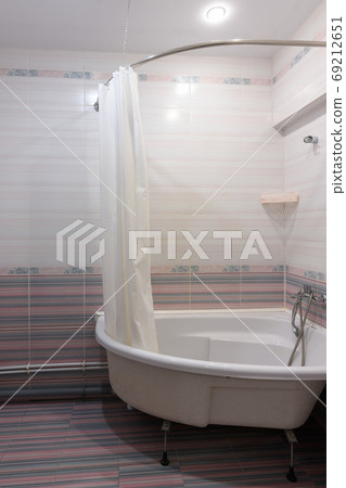 View of the acrylic bathtub in the bathroom interior View of the acrylic bathtub in the bathroom interior 69212651