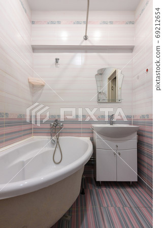 Vertical view of the interior of an ordinary habitable bathroom in the interior of a hotel room Vertical view of the interior of an ordinary habitable bathroom in the interior of a hotel room 69212654