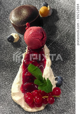 Chocolate cake dessert with ice cream on stone plate Chocolate cake dessert with ice cream on stone plate 69212664