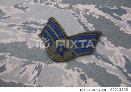 August 31, 2020. US AIR FORCE Senior Airman rank patch on digital tiger-stripe pattern Airman Battle Uniform (ABU) background August 31, 2020. US AIR FORCE Senior Airman rank patch on digital tiger-stripe pattern Airman Battle Uniform (ABU) background 69213266