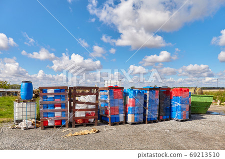 Chemicals in plastic containers at a dump site. Chemicals in plastic containers at a dump site. 69213510