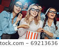 Young people friends together in the cinema 69213636