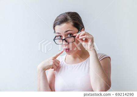 Beautiful happy girl smiling. Beauty simple portrait young smiling brunette woman in eyeglasses isolated on white background. Positive human emotion facial expression body language. Copy space 69214290