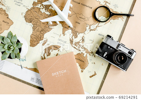 Planning vacation, travel plan, trip vacation using world map along with other travel accessories. Top view, flat lay. Planning vacation, travel plan, trip vacation using world map along with other travel accessories. Top view, flat lay. 69214291