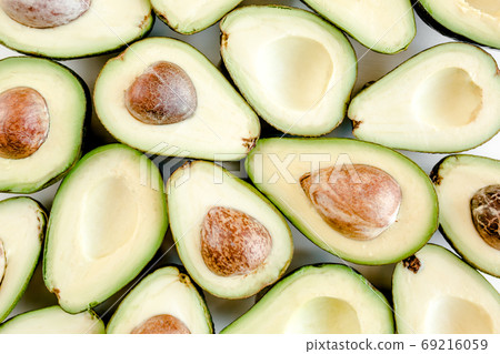 Avocado on pink background. Tropical abstract background with avocado. Food concept. flat lay, top view Avocado on pink background. Tropical abstract background with avocado. Food concept. flat lay, top view 69216059