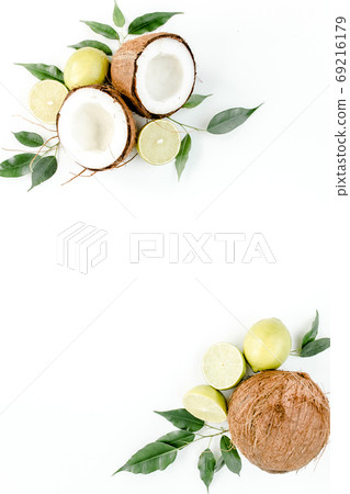 Creative pattern made of summer tropical fruits: coconut, lime and leaves ficus. Food concept. flat lay, top view 69216179