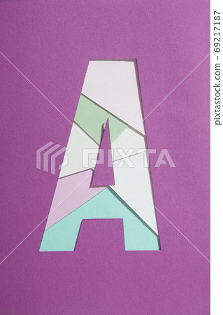 Composition image of letter A of the alphabet and colored paper in magenta color Composition image of letter A of the alphabet and colored paper in magenta color 69217187