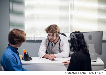 A mother and her teeange son at the doctors office, in the hospital A mother and her teeange son at the doctors office, in the hospital 69217374