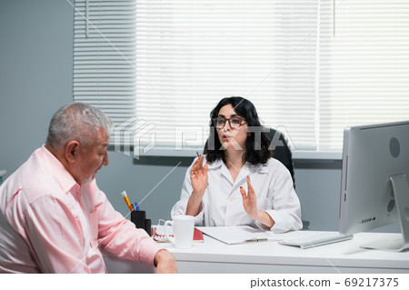 Female Doctor Consoling a Senior Patient In a Hospital 69217375