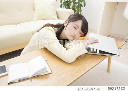 A woman tired from work A woman tired from work 69217585