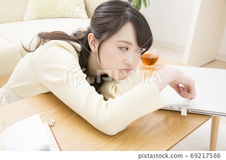 A woman tired from work 69217586