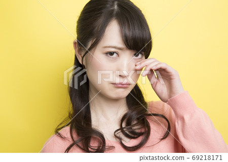 Woman wiping tears Woman wiping tears 69218171