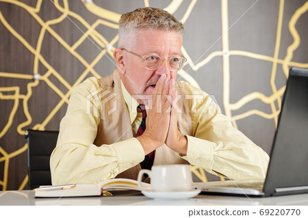 Businessman reading shocking news 69220770