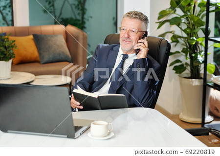 Senior entrepreneur talking on phone Senior entrepreneur talking on phone 69220819
