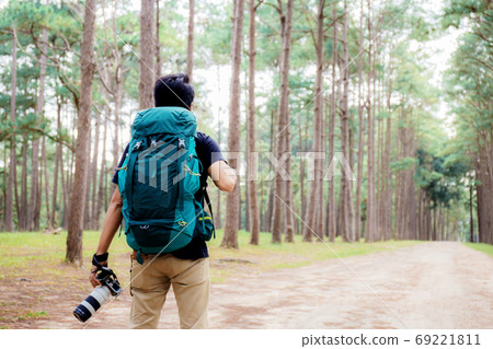 Photographer with traveling at pine tree park. Photographer with traveling at pine tree park. 69221811