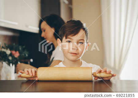 the baby makes cakes. the children were covered in flour. dinner at the bakery. feast in the kitchen 69221855