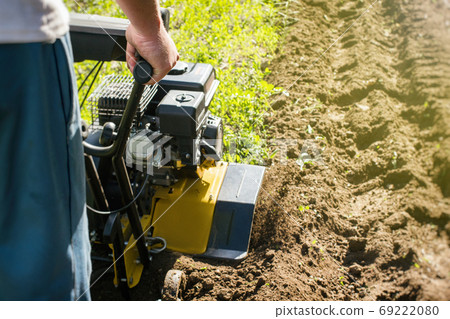 Outdoor garden plow job with a motor cultivator 69222080