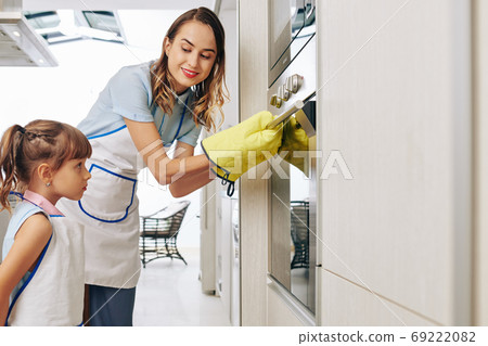 Opening oven with cake inside Opening oven with cake inside 69222082