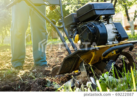 Grass and plowed soil nuggets during motor cultivator farm work Grass and plowed soil nuggets during motor cultivator farm work 69222087